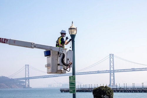 street light being repaired with Bay Bridge in the background