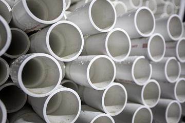 ends of a large stack of white pipes