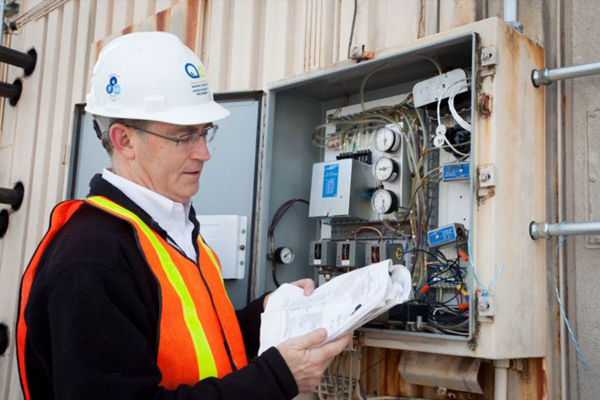 A power employee looks at a panel.