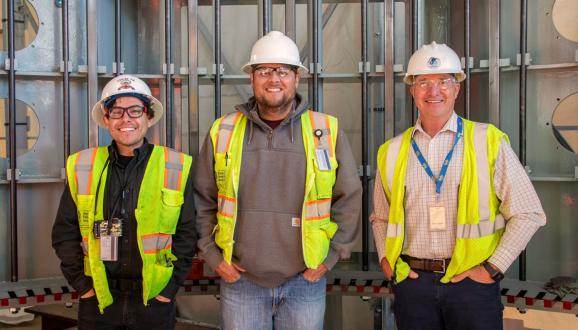 Construction Management Team standing inside the new hydroelectric generator. Left to Right: Juan Barrios (Engineer), Dustin Scholl (SFPUC Resident Engineer/Student Design Trainee), Tim Parkan (Project Manager).
